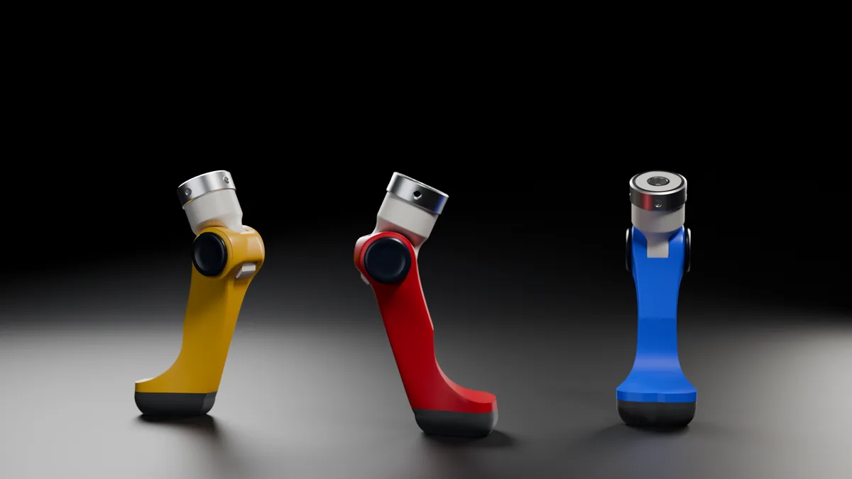 Three articulated 3D-printed tibial paws in gold, red and blue